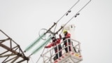 A photo taken on February 8, 2025 shows technicians on a hydraulic platform working to disconnect the major power line between Latvia and Russia in Vilaka, Latvia, near the Russian border.